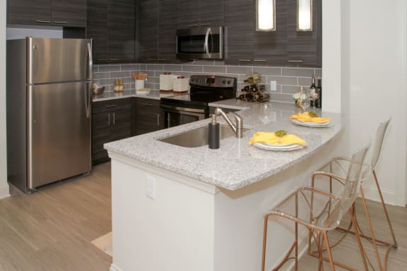 Model kitchen with granite countertops at Fifth Street Place Apartments, Charlottesville, VA, 22903