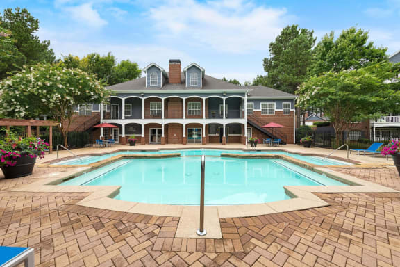 Pool and clubhouse at Sugarloaf Crossings Apartments in Lawrenceville, GA 30046
