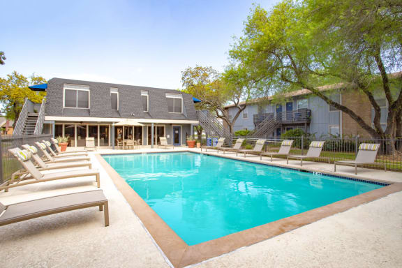 Swimming Pool With Lounge Chairs at Willowick Apartments, College Station