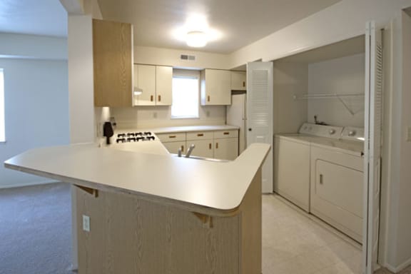 Spacious Kitchen with Breakfast Bar at Dupont Lakes Apartments in Fort Wayne, IN