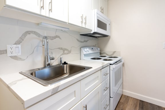 quartz countertop with kitchen sink and stove