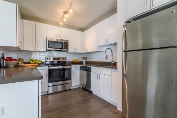 A spacious kitchen with stainless steel appliances at The Harbor.