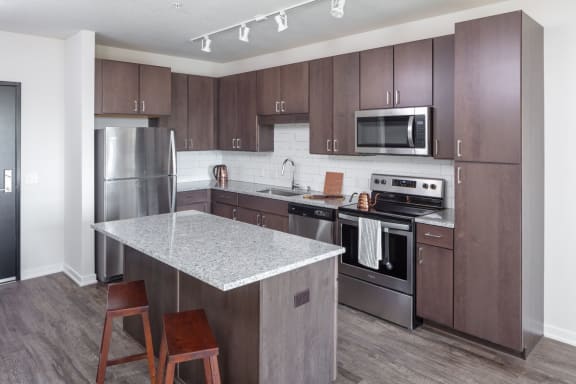New Apartments Rochester MN near Mayo Clinic with New Kitchens with Prep Island, Custom Cabinetry, Backsplash & Stainless Appliances-The Maven on Broadway