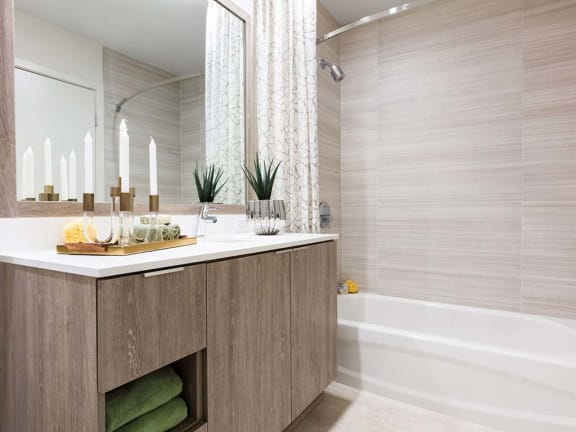 Bathroom vanity and tub. The Rey Apartments in California