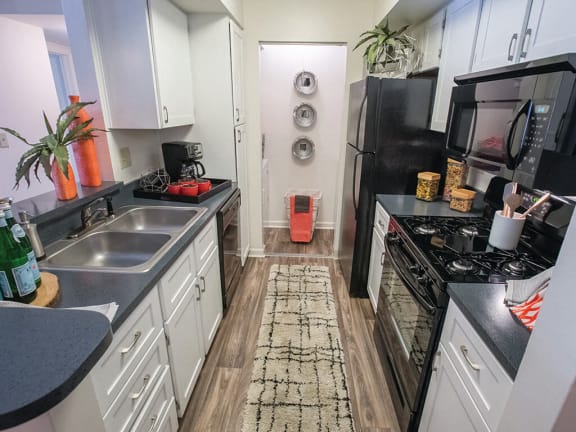 Kitchen with custom cabinetry at Saw Mill Village apartments