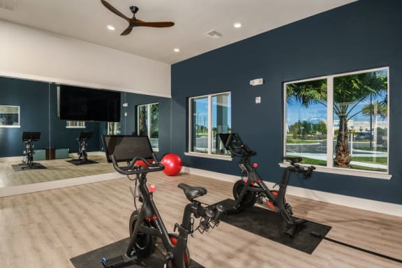 yoga room with peloton bikes at Luminary at 95 apartments West Melbourne FL