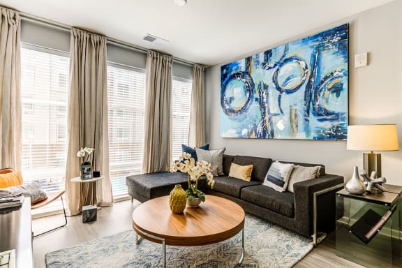 a living room with a large blue painting on the wall