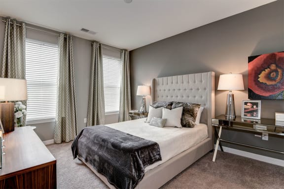 a bedroom with gray walls and a large bed at Aspire Apollo, Maryland, 20746