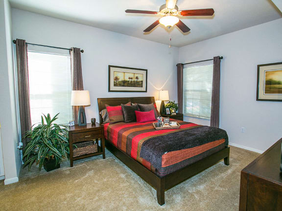 Spacious Model Bedroom with Carpeting and Ceiling Fan in Fairfield Apartments Near Me
