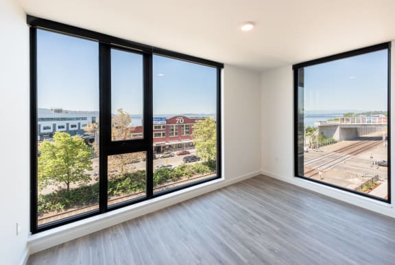 Living Room Features Large Windows and Beautiful Views at 10 Clay Apartments in Seattle, Washington, 98121