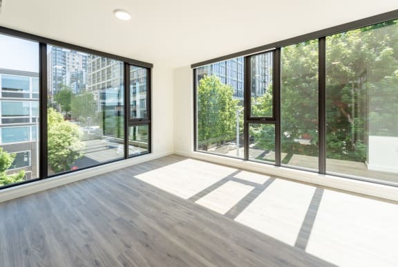 Master Bedroom With Spacious Interiors and Large Windows at 10 Clay Apartments in Seattle, Washington