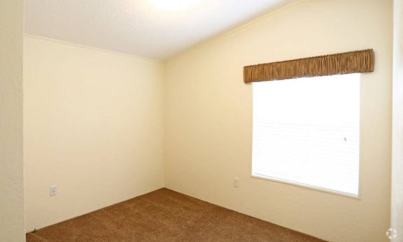 Bedroom With Carpeted Flooring and Window at Valley Ridge Rental Homes in San Antonio, Texas 78242