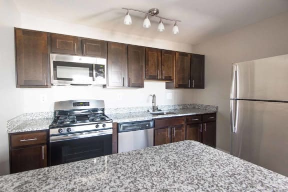 Gourmet Kitchen with Breakfast Bar and Pantry at Kenilworth at Perring Park Apartments, Parkville, Maryland
