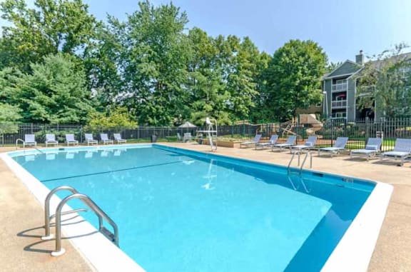 Swimming Pool Area with Shaded Chairs at The Crossings at White Marsh Apartments, Perry Hall, Maryland