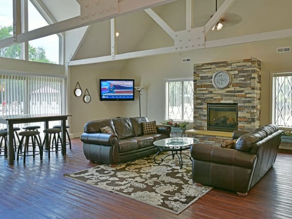 Large clubhouse with fireplace and TV at Charter Oaks Apartments in Davison, MI