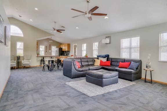 Common area with lounge area and kitchen in the clubhouse at Skyline View apartments