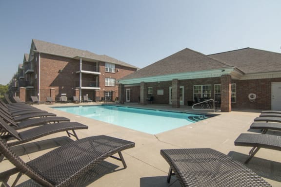 Swimming pool with sun tanning loungers at Williamsburg Park Apartments in South Lincoln, Nebraska