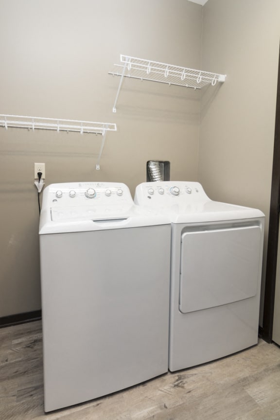 Laundry room with washer, dryer, and shelving Comfortable couch seating in the clubhouse at North Pointe Villas in north Lincoln, Nebraska