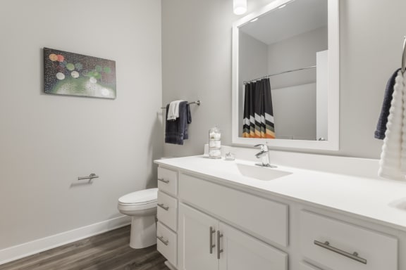 White bathroom vanity with framed mirror above