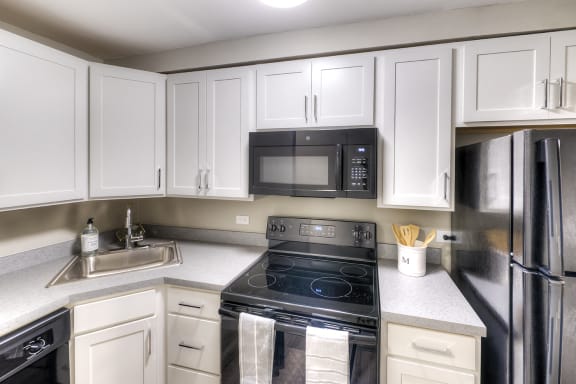 Modern Kithen with Wood Cabinets - Eagle Creek Apartments