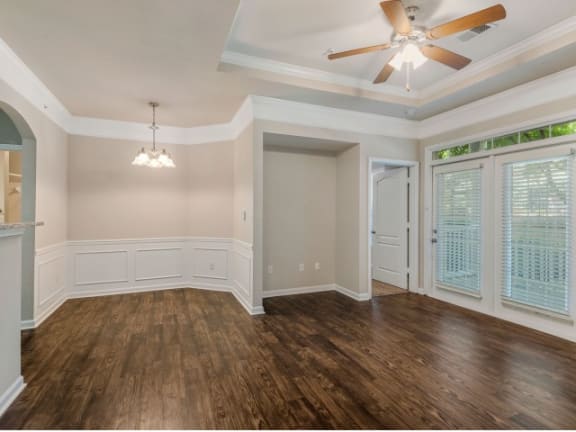 Modern Living Room with Elegant Crown Moulding and Wood Plank Vinyl Flooring (in Select Units) at Cambridge Square Apartments, Overland Park, KS 66211