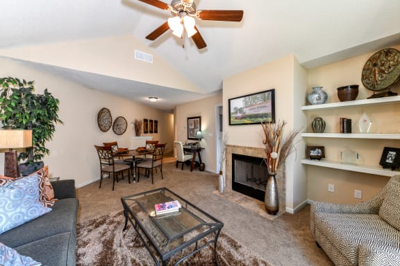 Gorgeous Modern Living Room with Elegant Crown Moulding and Wood Burning Fireplaces (in Select Units) at Pointe Royal Townhome Apartments, Overland Park, KS 66213