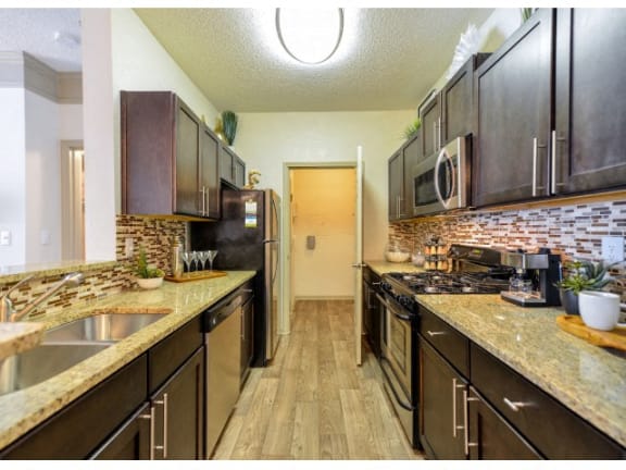 Gourmet Kitchens with Granite Countertops and Tile Backsplash at St. Andrews Apartment Homes, Johns Creek, Georgia