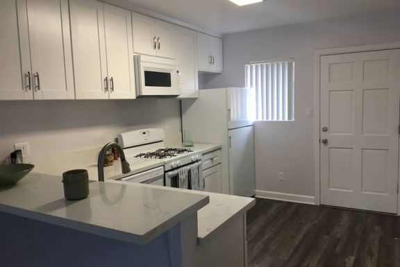 Thumbnail 10 of 30 - Custom White Cabinetry at Marine View Apartments, San Pedro