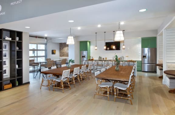 White Kitchens with Side by Side Fridge, Granite Countertop, Designer Ceramic Tile Backsplash and Glass Top Ranges at The Edison Apartments, Fort Myers, FL 33905