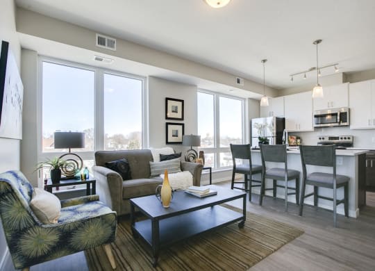 Open floor plan with white cabinetry and hardwood-style floors at The Central apartments near downtown Minneapolis MN 55408