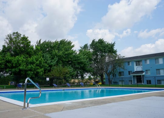 Resort Style Swimming Pool with pool chairs and easy entry, at Gale Gardens Apartments