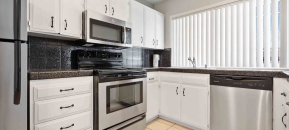 Apartments for Rent in Gilroy - Mission Park Apartments Kitchen with Stainless Steel Appliances, Sleek White Cabinets, and Modern Finishes