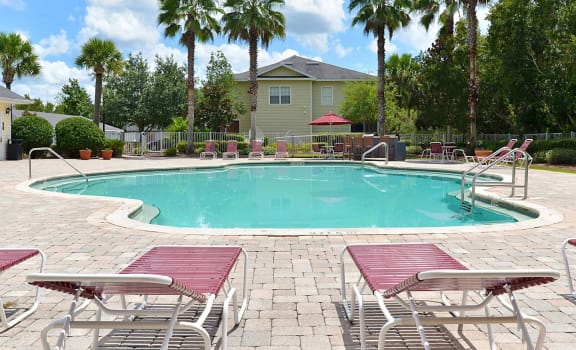 Exterior Pool Lounge Chairs at Magnolia Place Apartments, Gainesville, 32606