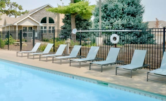 Relaxing swimming pool with lounging for sun tanning at Skyline View Apartments in South Lincoln, Nebraska