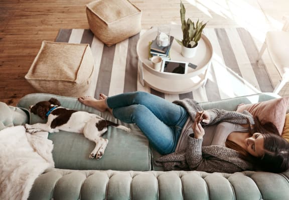 stock image- woman on couch with pet