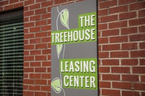 The Treehouse Leasing Center sign
