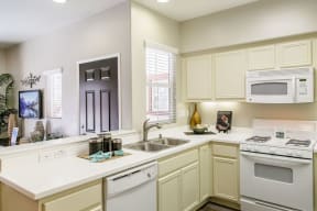 High Desert CA Apartments for Rent - Spacious Kitchen Featuring Convenient Amenities Such as Dishwasher, Stove, and Microwave