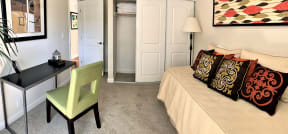 guest bedroom in 2 bedroom model with twin size bed,
standard size closet,
small desk with chair