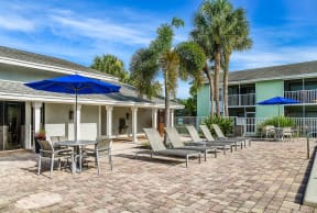 Poolside patio with lounge chairs | Jupiter Isle