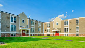 Exterior lawn and entry to Boulders apartment buildings