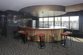 7th Floor social room with curved bar and barstools