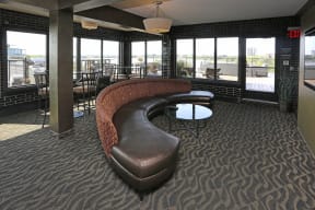 7th floor social room with semi circle couch and tall tables