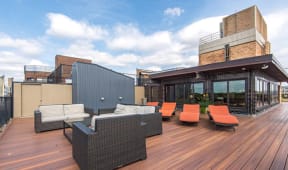 Roof top outdoor lounge with wood panel flooring, lounge furniture