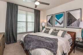 Spectacular bedroom with carpeted flooring and one enormous window in Orlando, FL apartment for rent