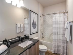 Spacious bathroom with toilet and bathtub in Coda Orlando apartment rentals in Orlando, FL