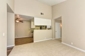 Empty Living Room with Carpet, View of Kitchen, Ceiling Fan/Light