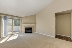 Empty Living Room with Carpet, Large Window and Fire Place