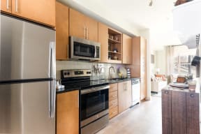 Fully Equipped Kitchen Includes Frost-Free Refrigerator, Electric Range, & Dishwasher at Station 40, Nashville