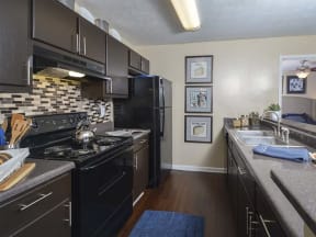 Harvard Place Apartments, Lithonia GA, model apartment kitchen espresso cabinets