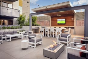 outdoor lounge with firepits and TV